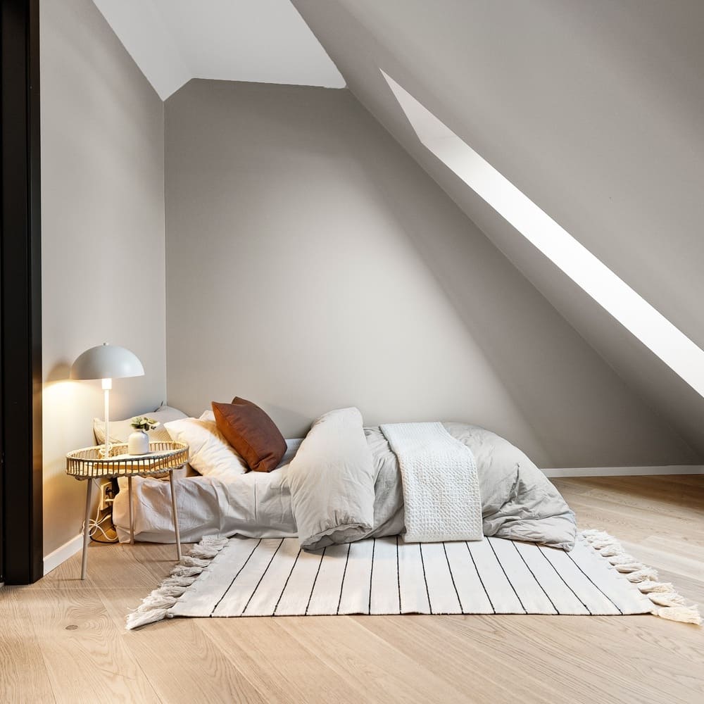 Modern bedroom with minimalist decor and cozy lighting, featuring large windows and a comfortable bed