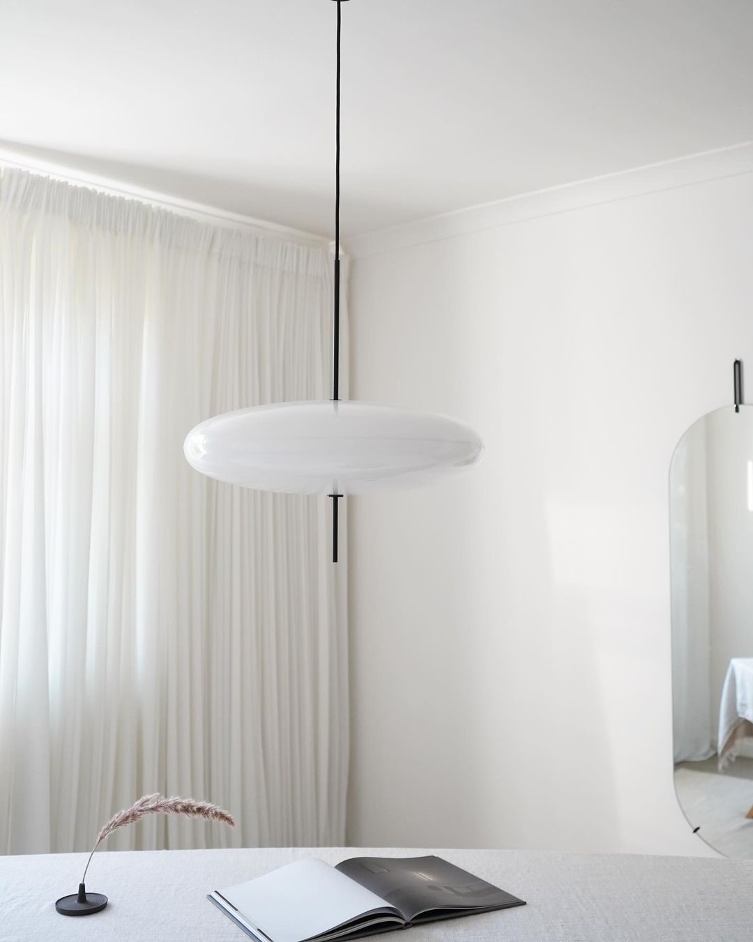 Minimalist Elliptical Pendant Light with Vertical Rod