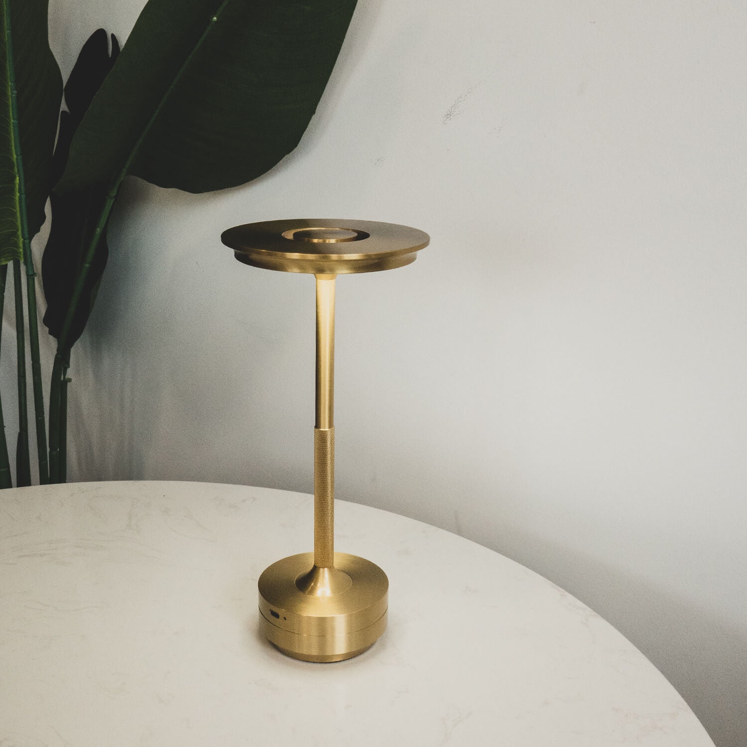 Compact gold table lamp with rechargeable battery, perfect for a modern interior.