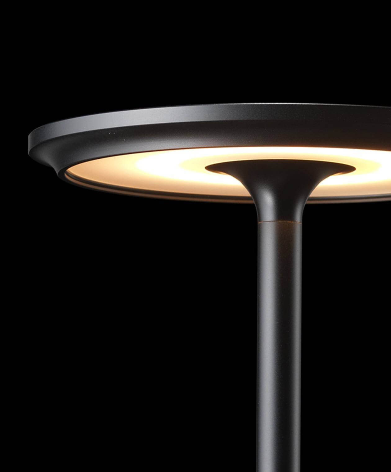 Close-up of the LED lighting section of a black cordless table lamp with a minimalist design.