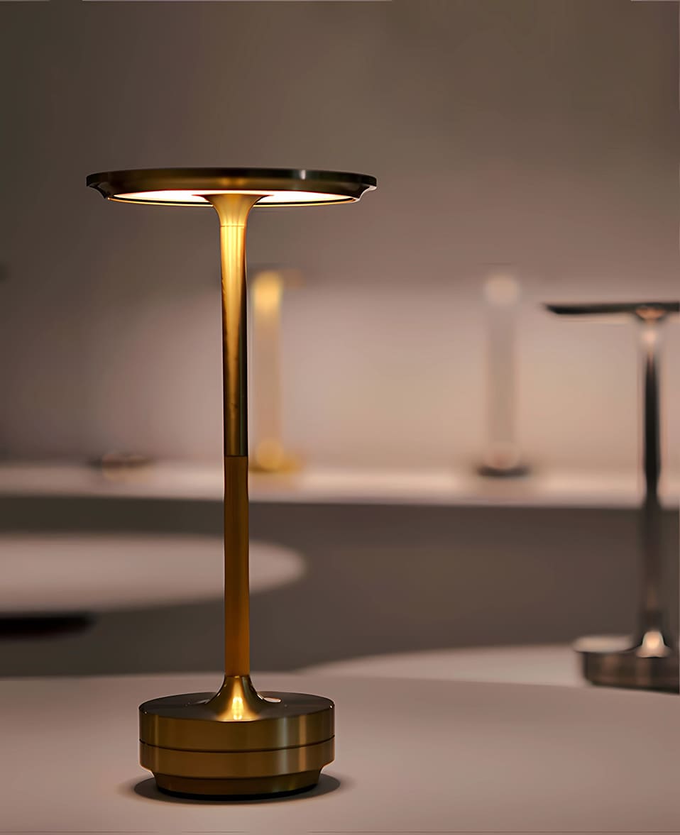 Cordless rechargeable brass table lamp with dimmable LED lighting, modern design for indoor use.