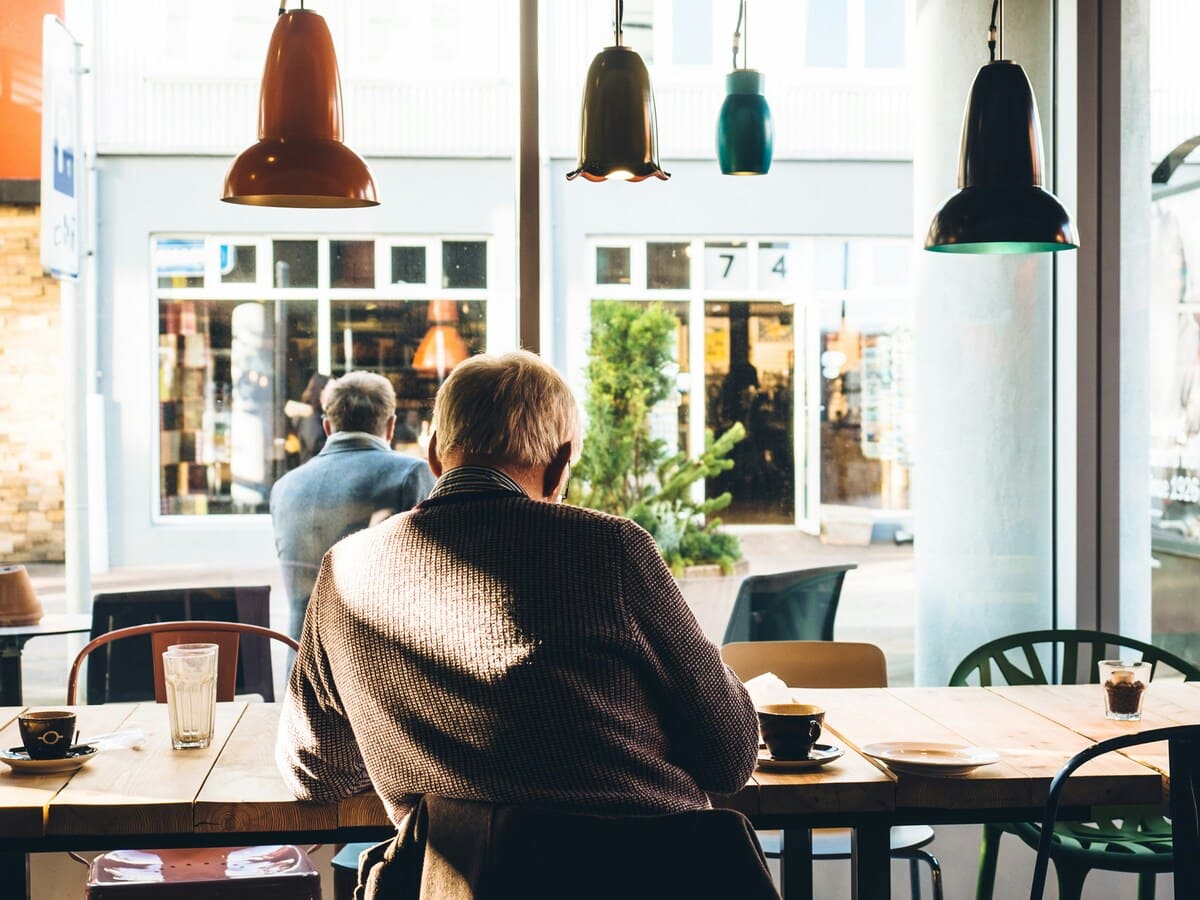 Cafe interior with stylish hanging lights and cozy seating area.