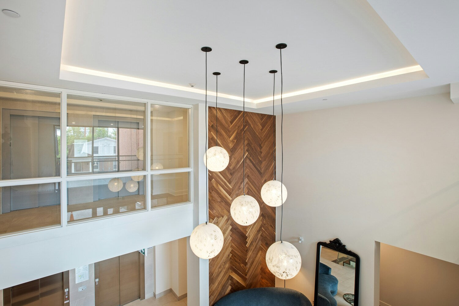 Foyer with custom spherical pendant lights and a contemporary design.