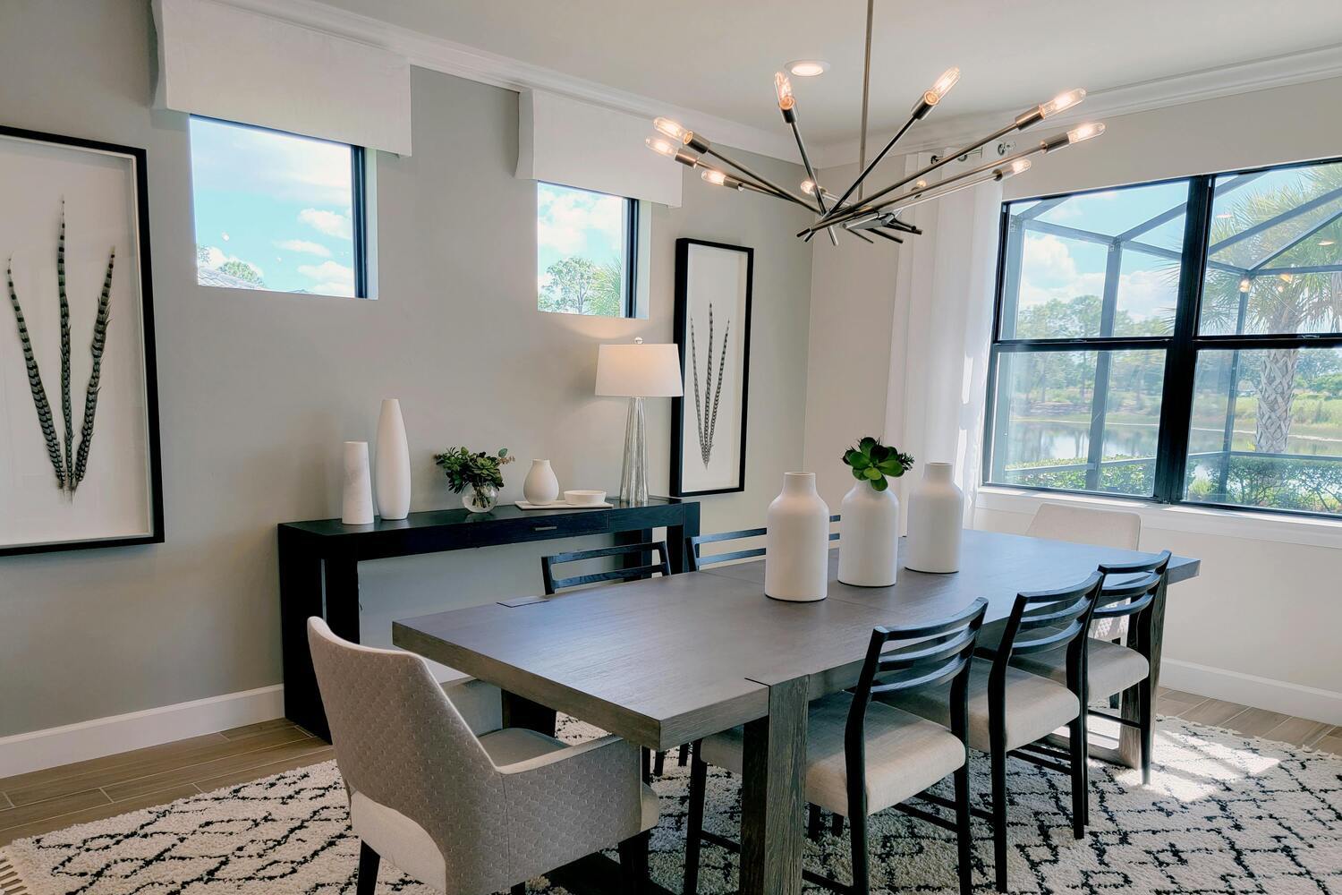 Modern dining room with a custom chandelier and minimalist decor.