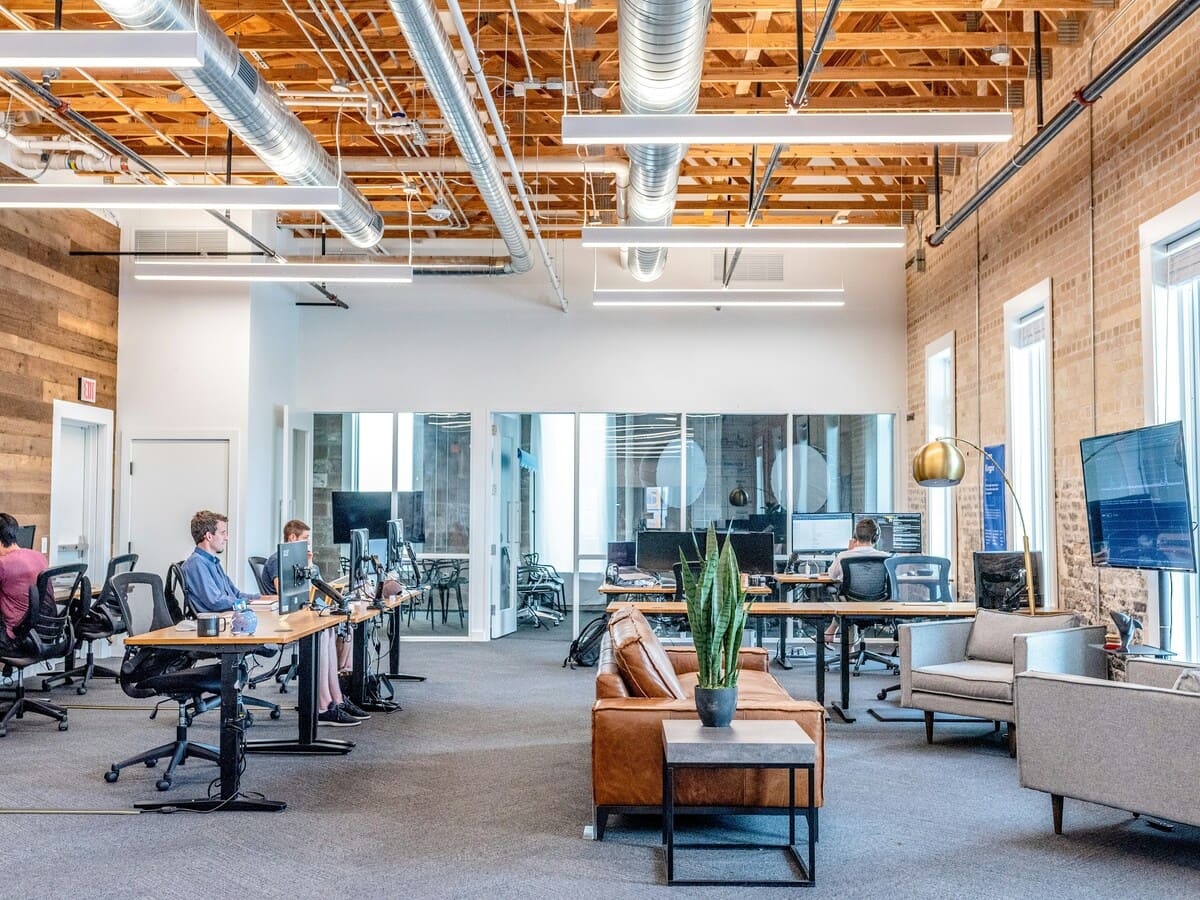 Modern open office space with custom lighting and industrial design elements.