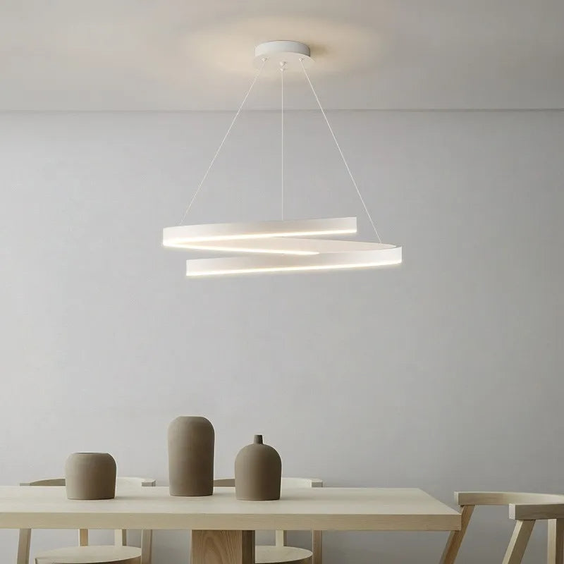 White modern pendant light with adjustable dimmable LED rings in a dining room