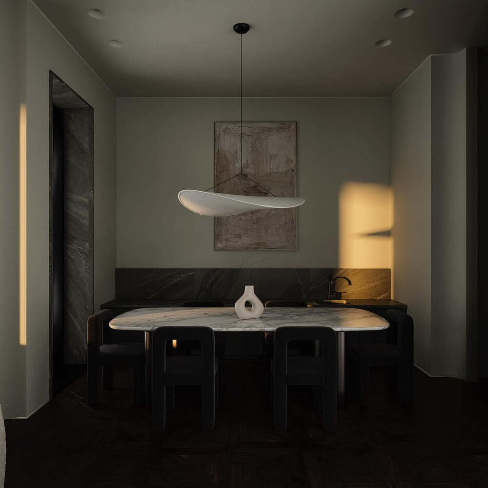 Tense Pendant Light casting a soft glow in a dark, moody dining room setting.